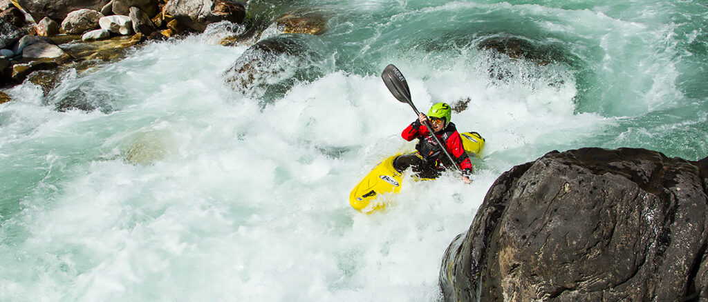 Female kayaker in turbulent rapid on Middle Paro Chu Bhutan